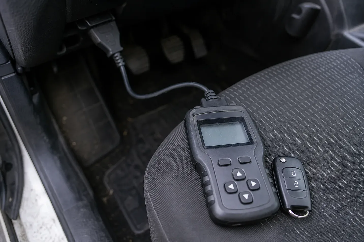 Car key programmer plugged into the OBD port in Waterbury, CT
